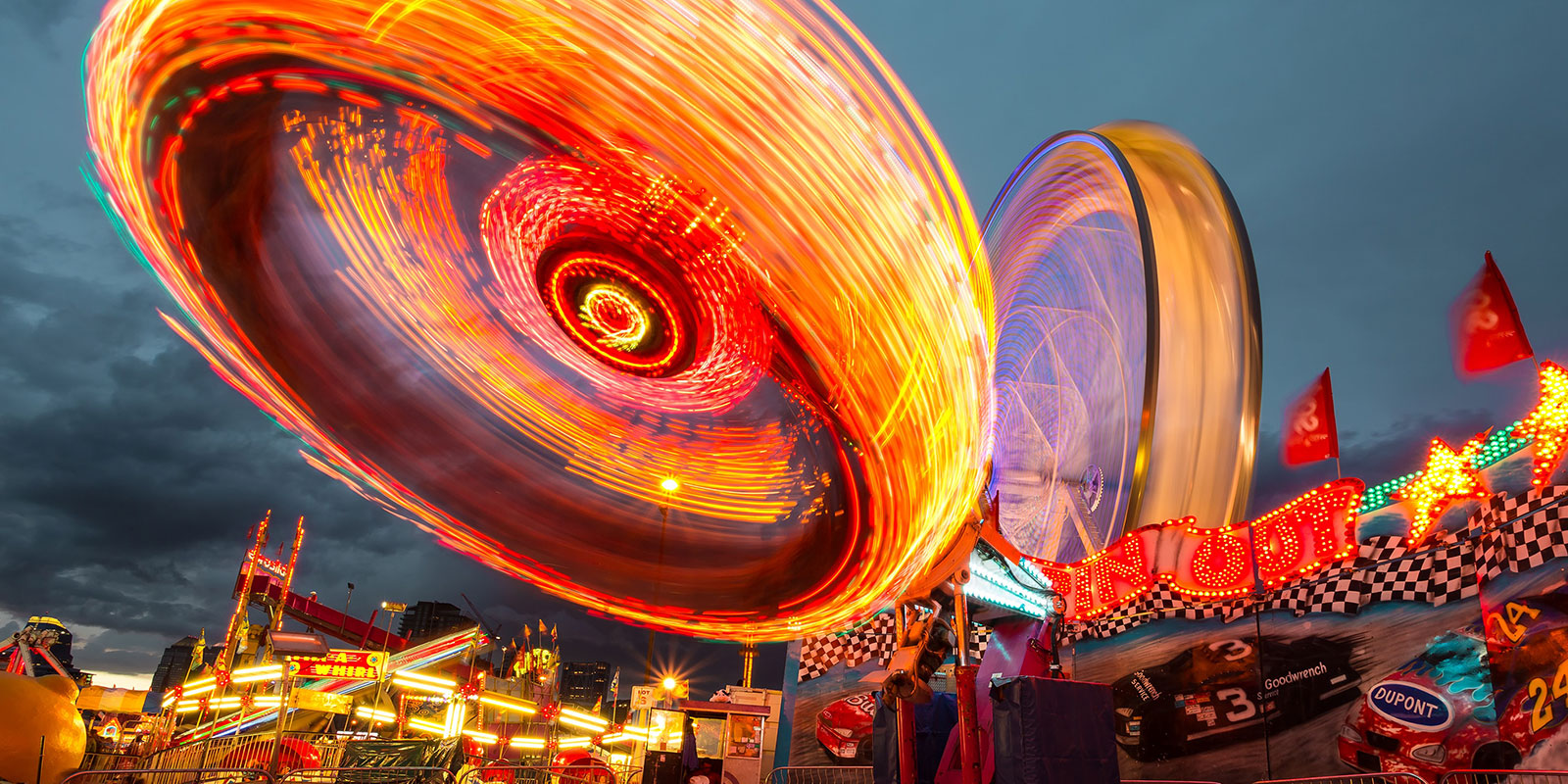 Time lapse photography of an amusement park at night with bright lights to illustrate speed associated with The Nano Sprint
